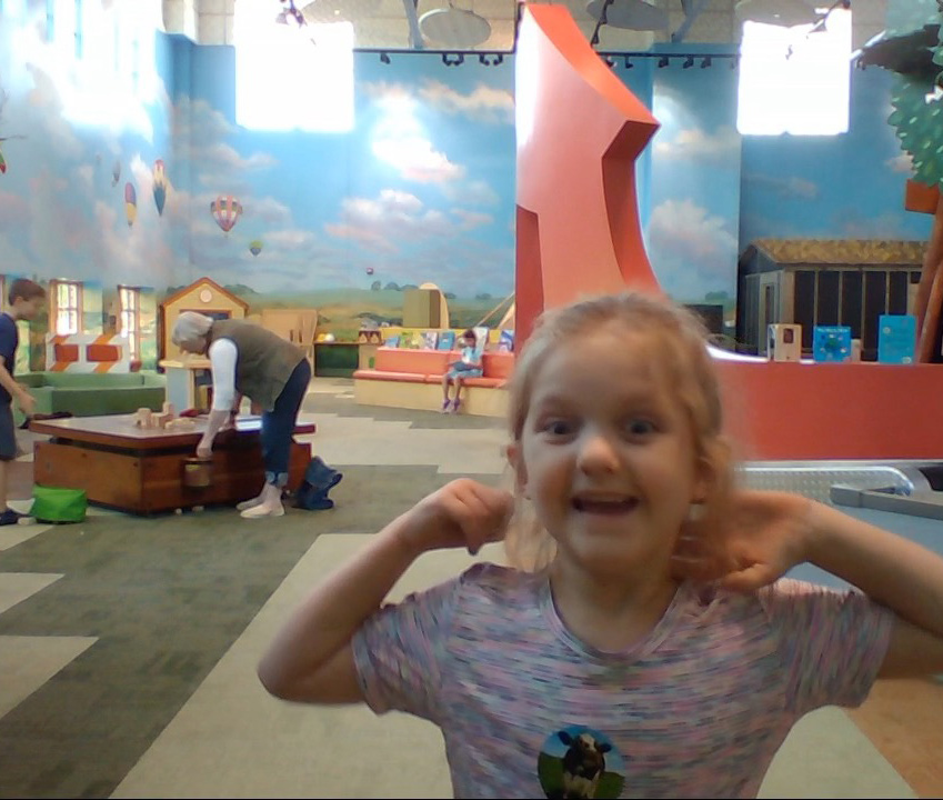 Animated girl smiling and describing her favorite children's museum exhibit.
