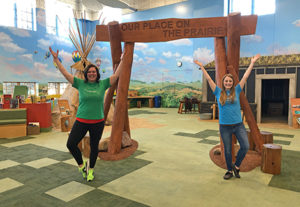 Mandy and Lauren doing a yoga pose on the indoor prairie at the Children's Museum of South Dakota