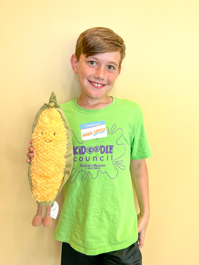 boy holding plush corn