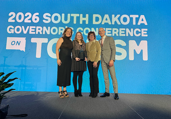 Left to right: Director of Marketing & Communications Kerrie Vilhauer, Education Manager Lauren Dietz, Executive Director Kate Treiber, and Secretayr of Tourism Jim Hagen celebrate Lauren's hospitality award.